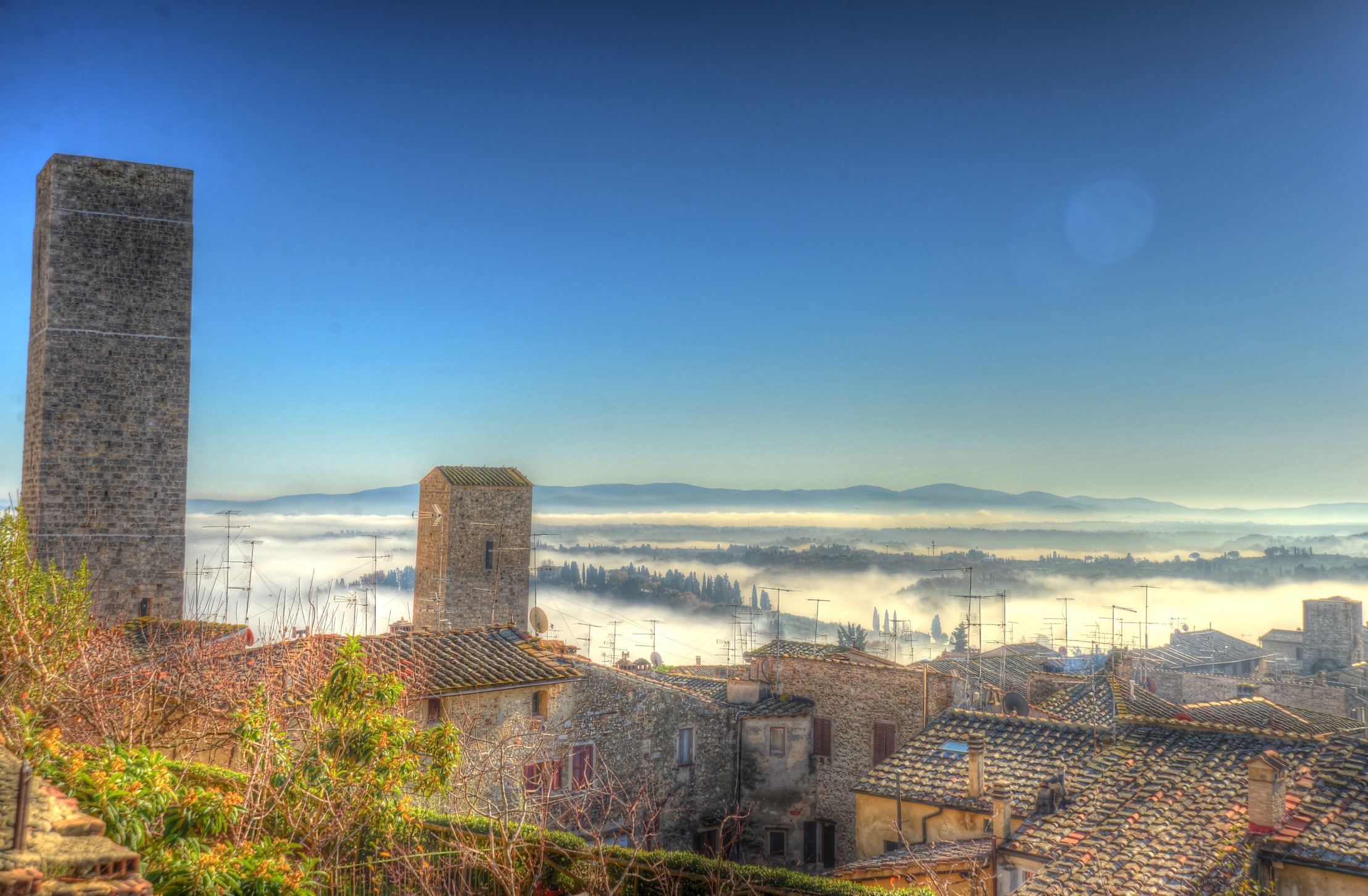 Morning fog around San Gimignano, classic tuscan landscape